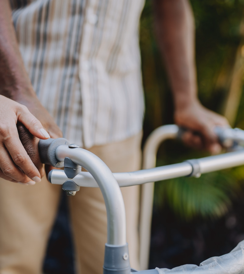 Caregiver assisting a patient using a walker